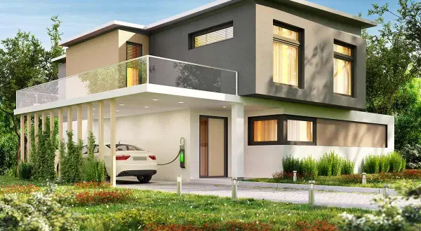 Moderna casa con colore esterno casa sabbia e grigio, auto elettrica in carica, giardino curato e cielo azzurro.