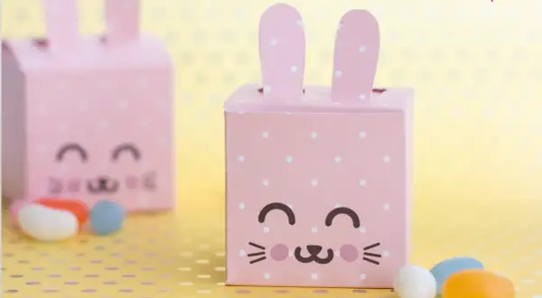 Dolci idee porta caramelle fai da te per bambini: scatoline rosa a pois a forma di coniglietto, perfette per Pasqua.