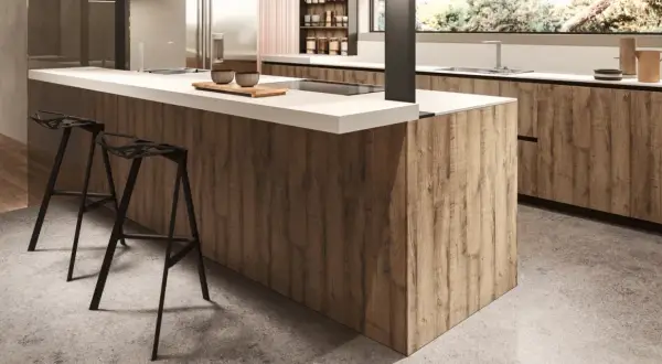 Modern kitchen island with wood-look melamine cabinets and white countertop, featuring black bar stools.