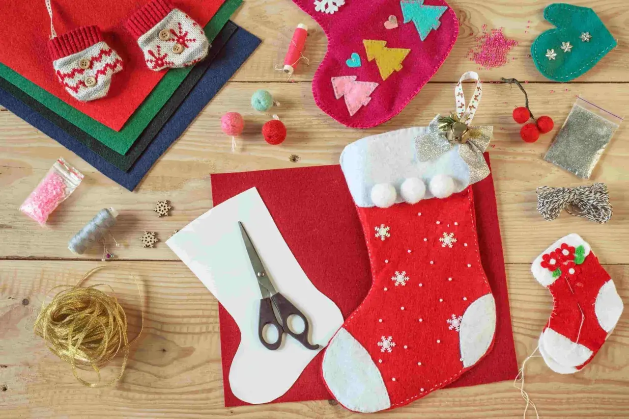 Materiali per calze Befana personalizzate fai da te: pannolenci, forbici, filo, perline e decorazioni.